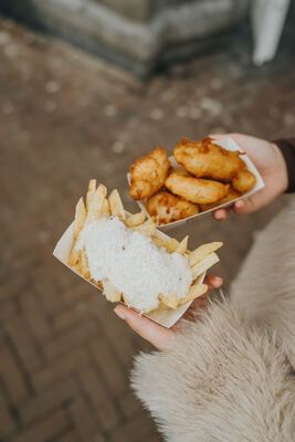 Two trays from above: Vleminckx fries with Parmesan and golden battered cod